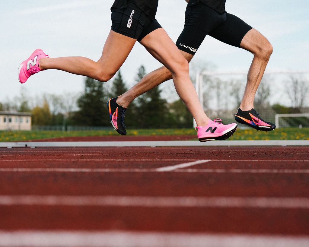 Two runners at the track in track spikes